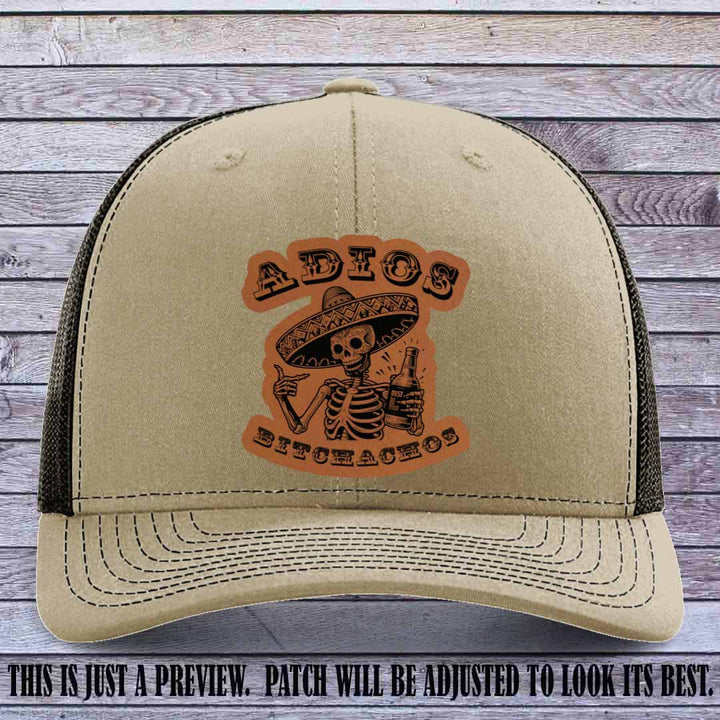 Rawhide leather patch on Khaki to Coffee Richardson 112 trucker hat featuring “Adios Bitchachos” skeleton design.