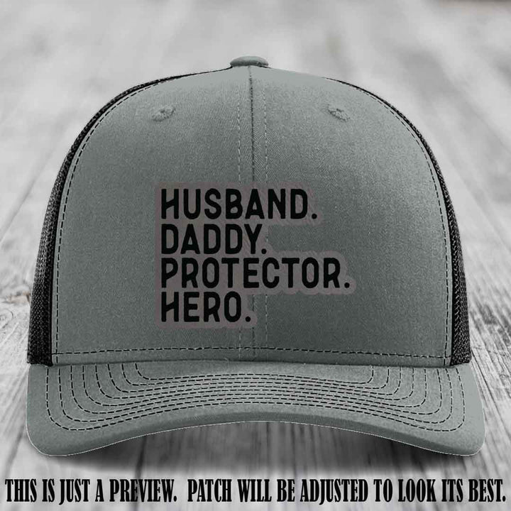Husband. Daddy. Protector. Hero. Grey to Black Patch on Heather Grey to Black Hat - Richardson 112 Hat