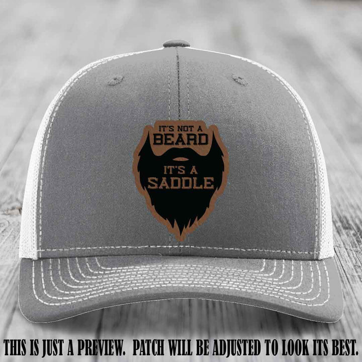 Beard Saddle design on a Dark Brown to Black Patch, Richardson 112 leather patch hat on a Heather Grey to White Hat