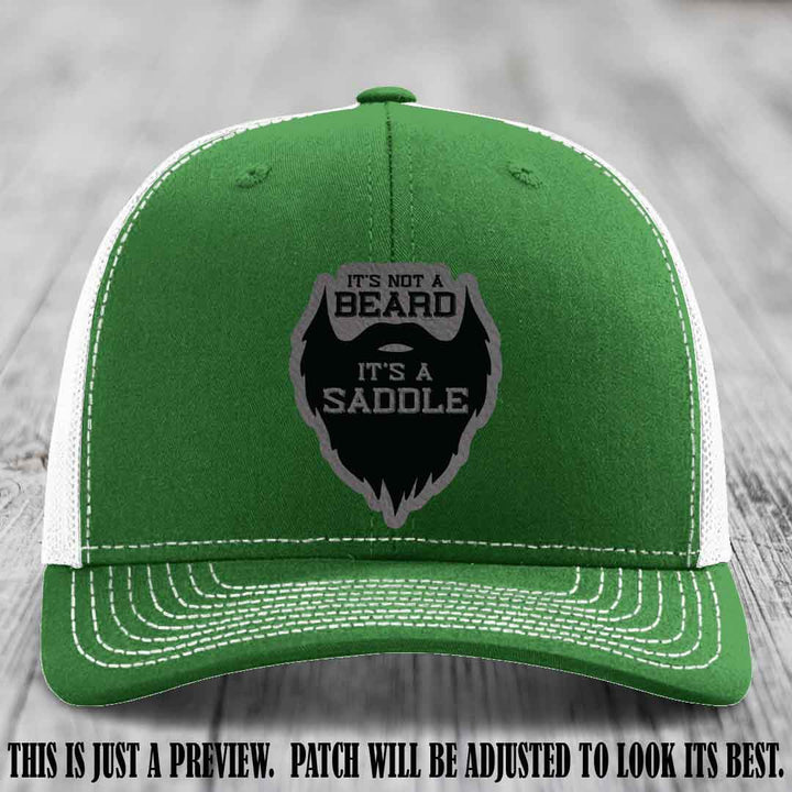 Beard Saddle design on a Grey to Black Patch, Richardson 112 leather patch hat on a Kelly to White Hat