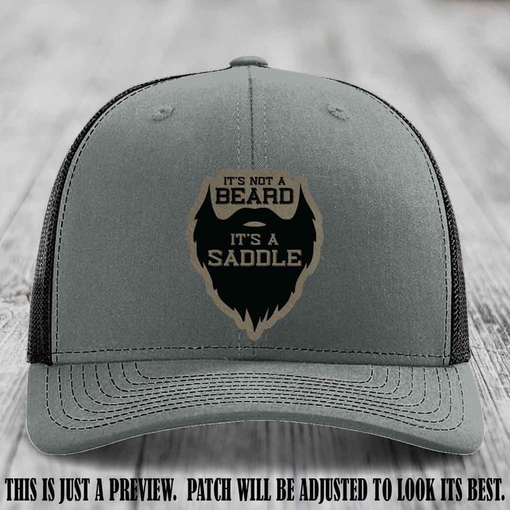 Beard Saddle design on a Light Brown to Black Patch, Richardson 112 leather patch hat on a Heather Grey to Black Hat