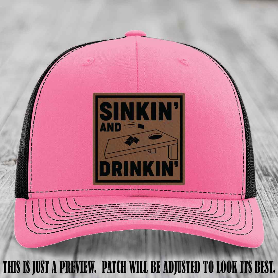 Sinkin' and Drinkin' design on Dark Brown to Black Patch, Richardson 112 Hot Pink to Black Hat