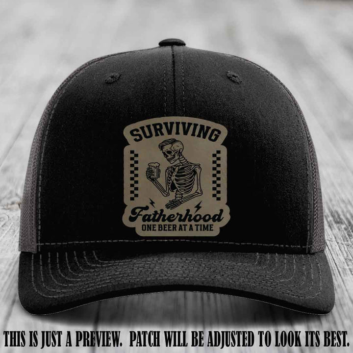Surviving Fatherhood - Light Brown to Black Patch on Black to Charcoal Hat, funny dad hat