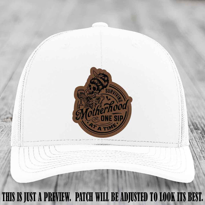 Surviving Motherhood One Sip at a Time Dark Brown to Black Patch on Richardson 112 Hat - White Hat