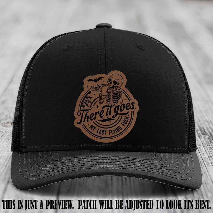 There It Goes design on Dark Brown to Black Patch, displayed on a Black Hat, funny Richardson 112 leather patch hat