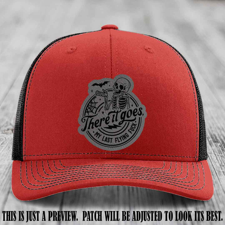 There It Goes design on Grey to Black Patch, displayed on a Red to Black Hat, funny Richardson 112 leather patch hat