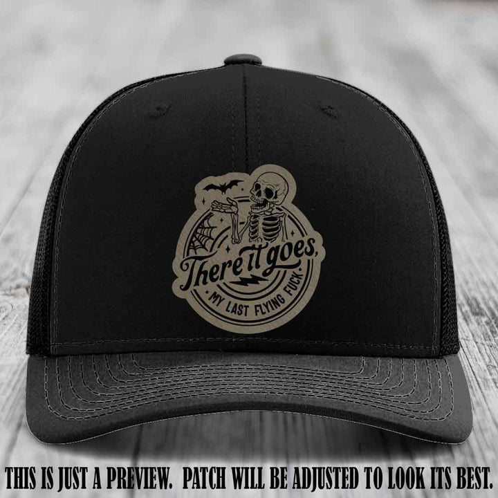 There It Goes design on Light Brown to Black Patch, displayed on a Black Hat, funny Richardson 112 leather patch hat