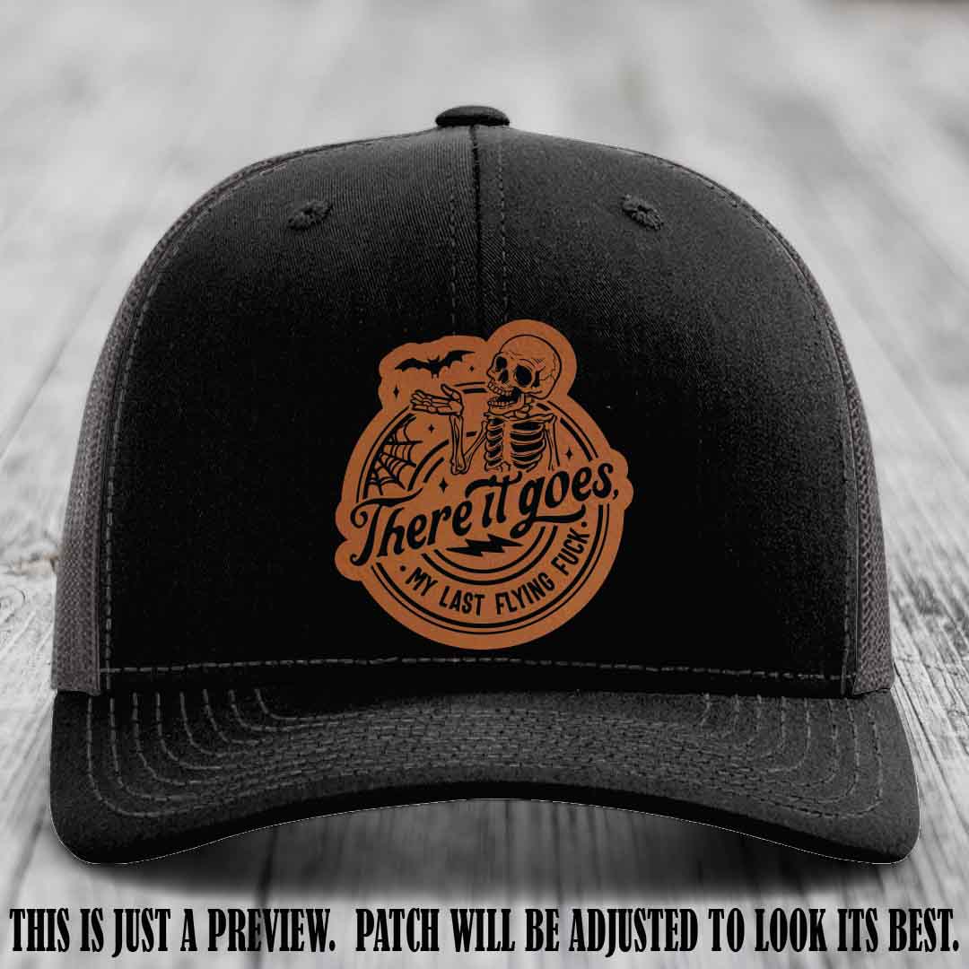 There It Goes design on Rawhide to Black Patch, displayed on a Black to Charcoal Hat, funny Richardson 112 leather patch hat
