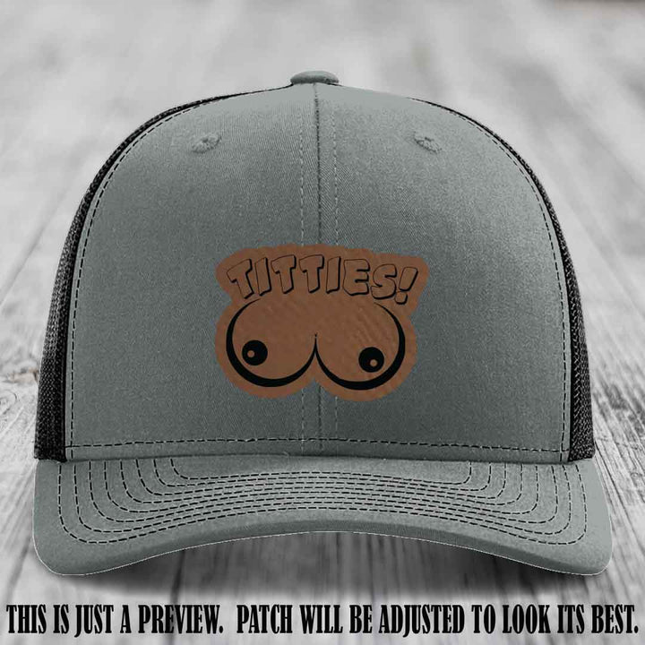 TITTIES! leather patch on Dark Brown to Black Patch mounted on a Heather Grey to Black Hat – Richardson 112 funny trucker hat
