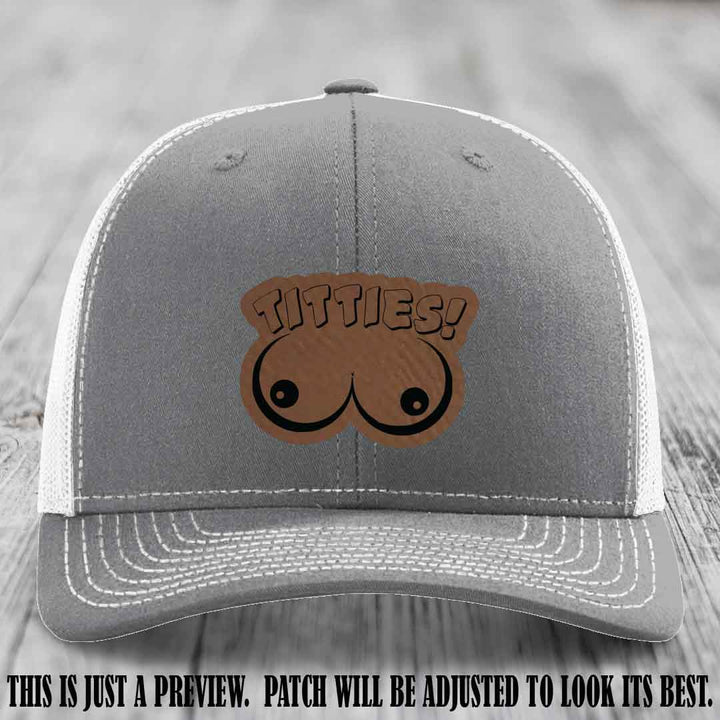TITTIES! leather patch on Dark Brown to Black Patch mounted on a Heather Grey to White Hat – Richardson 112 funny trucker hat