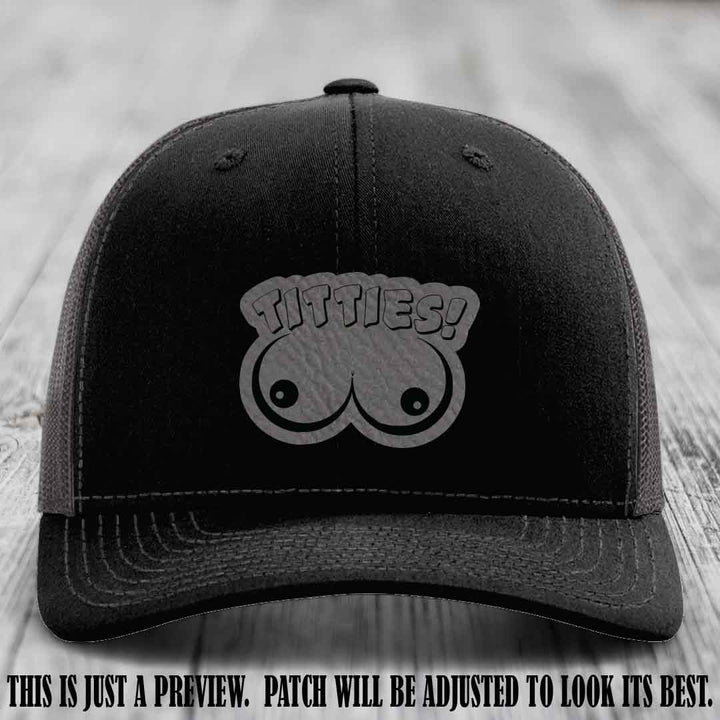 TITTIES! leather patch on Grey to Black Patch mounted on a Black to Charcoal Hat – Richardson 112 funny trucker hat