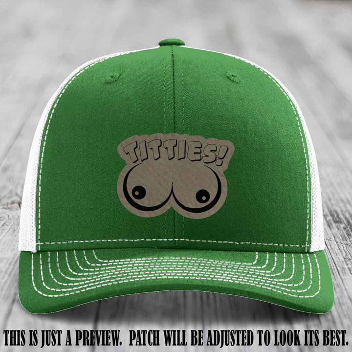 TITTIES! leather patch on Light Brown to Black Patch mounted on a Kelly to White Hat – Richardson 112 funny trucker hat