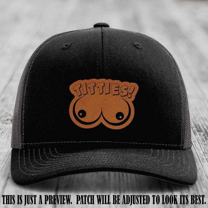 TITTIES! leather patch on Rawhide to Black Patch mounted on a Black to Charcoal Hat – Richardson 112 funny trucker hat