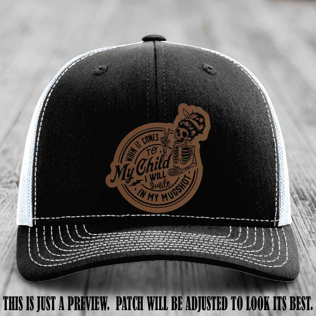 Richardson 112 custom trucker hat with dark brown to black patch and 'My Child Mugshot' leather patch on black to white hat