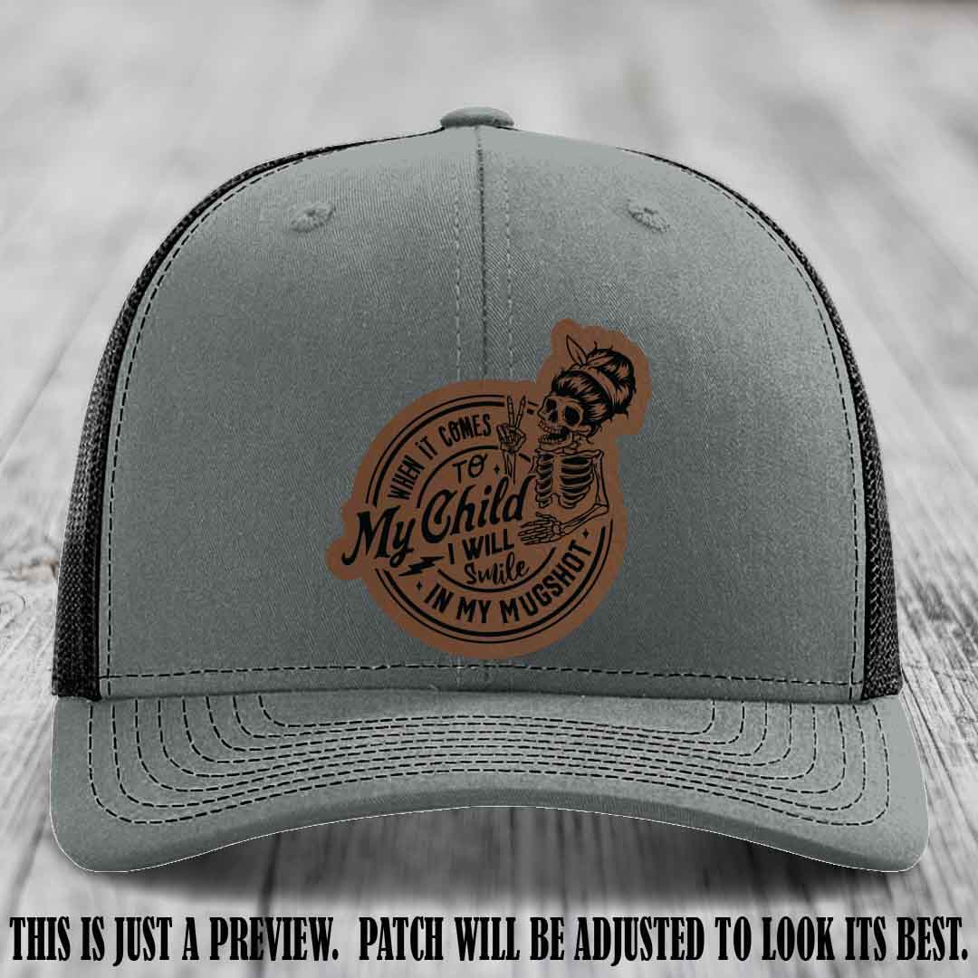 Richardson 112 custom trucker hat with dark brown to black patch and 'My Child Mugshot' leather patch on heather grey to black hat