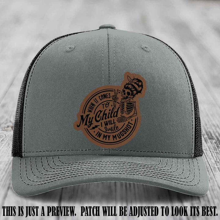 Richardson 112 custom trucker hat with dark brown to black patch and 'My Child Mugshot' leather patch on heather grey to black hat