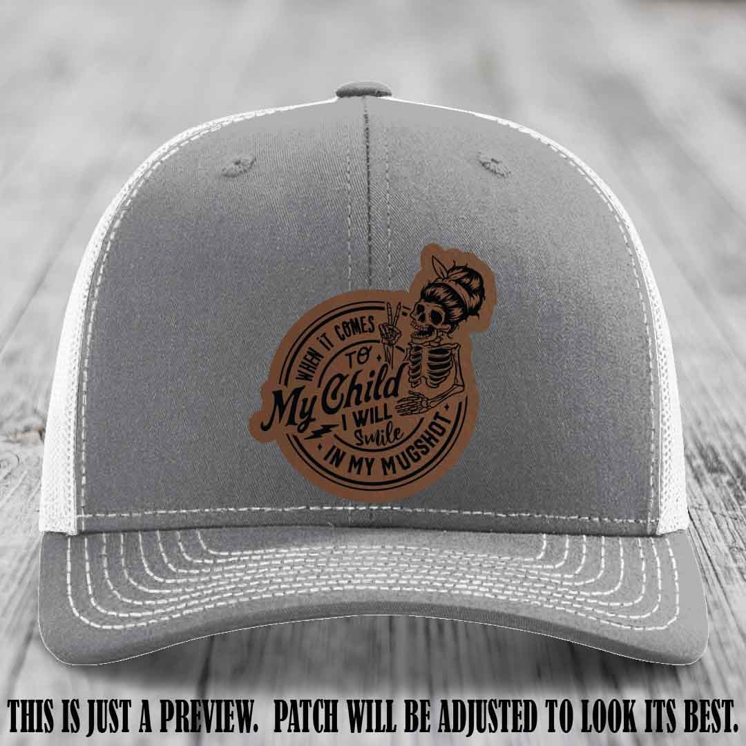 Richardson 112 custom trucker hat with dark brown to black patch and 'My Child Mugshot' leather patch on heather grey to white hat