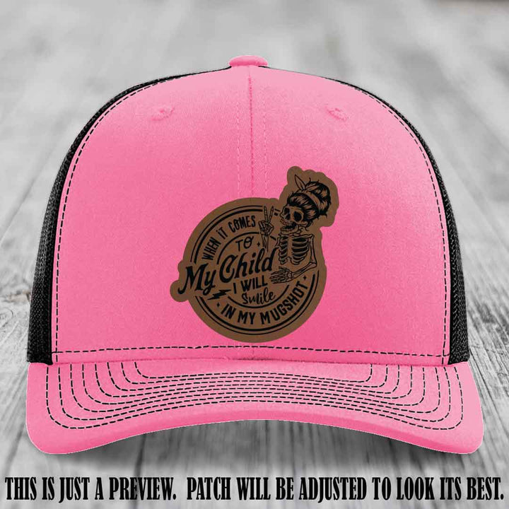 Richardson 112 custom trucker hat with dark brown to black patch and 'My Child Mugshot' leather patch on hot pink to black hat
