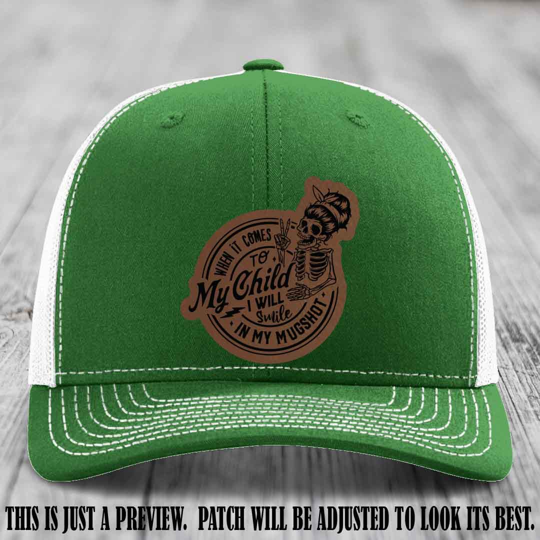 Richardson 112 custom trucker hat with dark brown to black patch and 'My Child Mugshot' leather patch on kelly to white hat