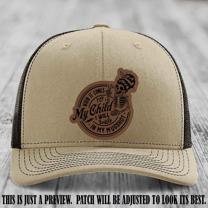 Richardson 112 custom trucker hat with dark brown to black patch and 'My Child Mugshot' leather patch on khaki to coffee hat