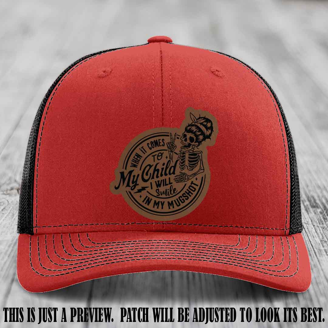 Richardson 112 custom trucker hat with dark brown to black patch and 'My Child Mugshot' leather patch on red to black hat