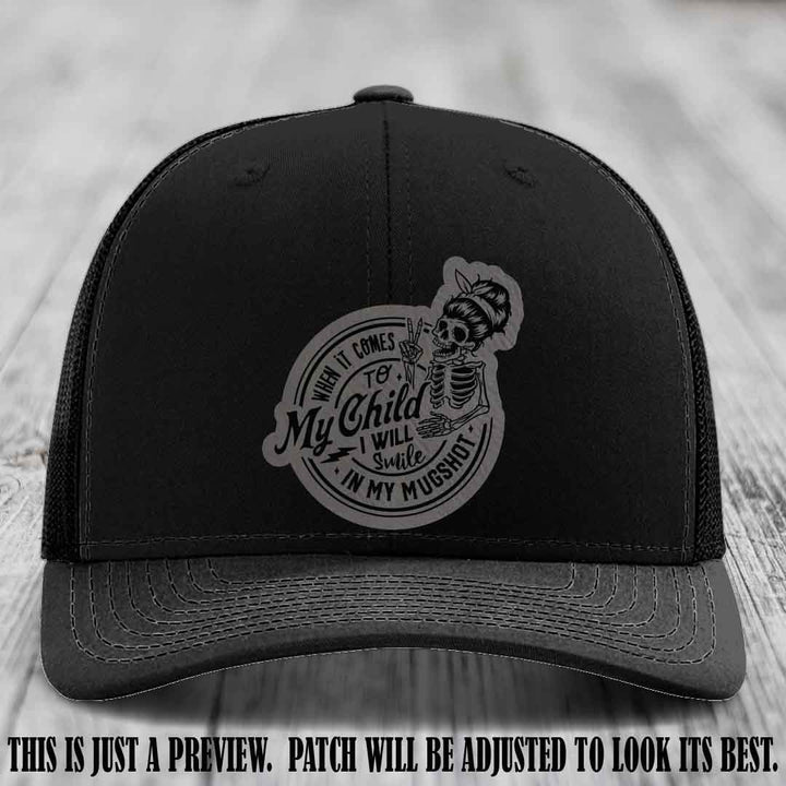 Richardson 112 custom trucker hat with grey to black patch and 'My Child Mugshot' leather patch on black hat