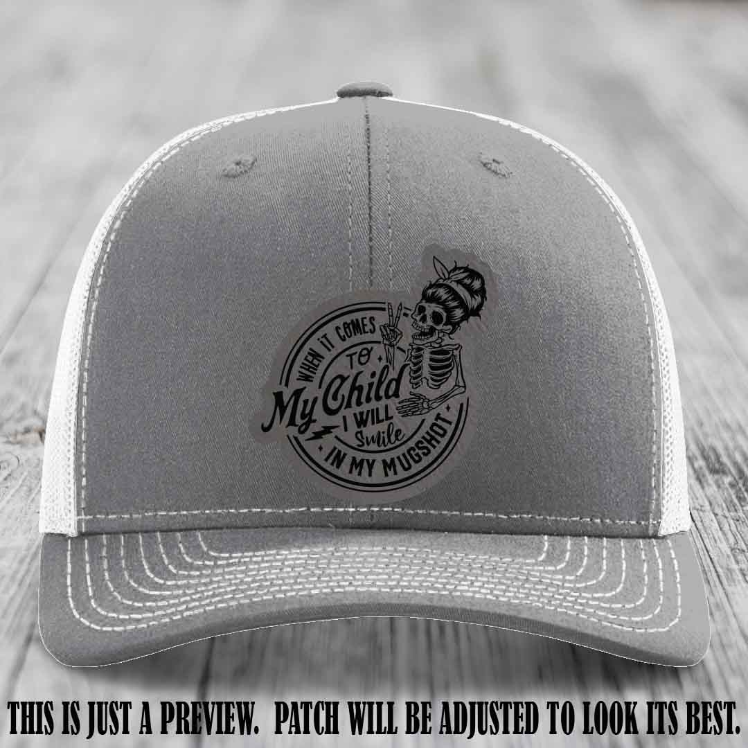 Richardson 112 custom trucker hat with grey to black patch and 'My Child Mugshot' leather patch on heather grey to white hat