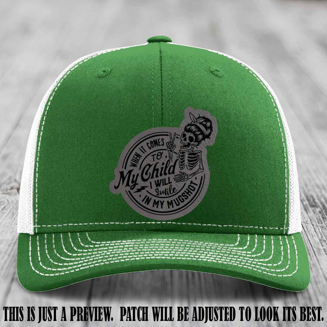 Richardson 112 custom trucker hat with grey to black patch and 'My Child Mugshot' leather patch on kelly to white hat