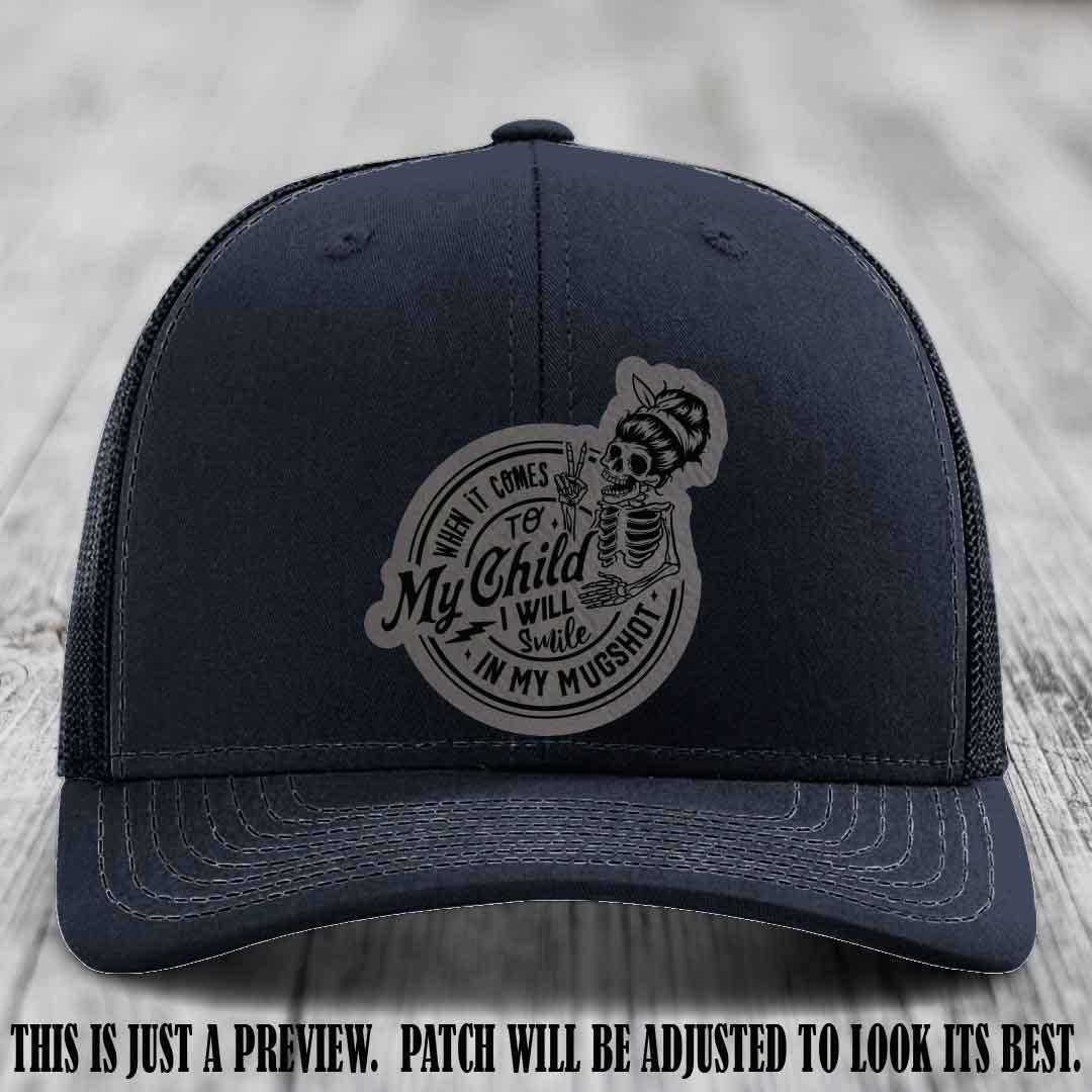 Richardson 112 custom trucker hat with grey to black patch and 'My Child Mugshot' leather patch on navy hat