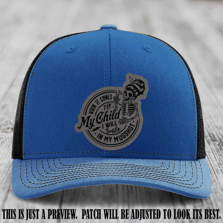 Richardson 112 custom trucker hat with grey to black patch and 'My Child Mugshot' leather patch on royal to black hat