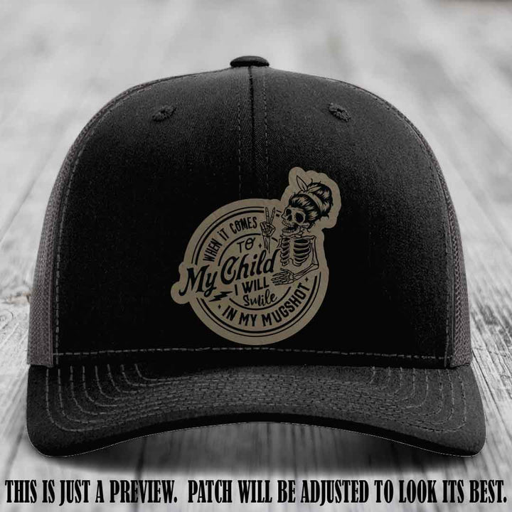 Richardson 112 custom trucker hat with light brown to black patch and 'My Child Mugshot' leather patch on black to charcoal hat