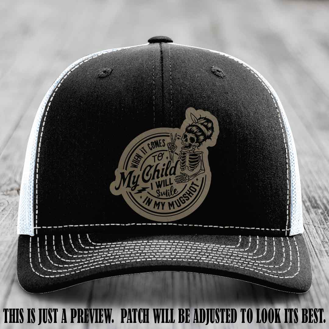 Richardson 112 custom trucker hat with light brown to black patch and 'My Child Mugshot' leather patch on black to white hat