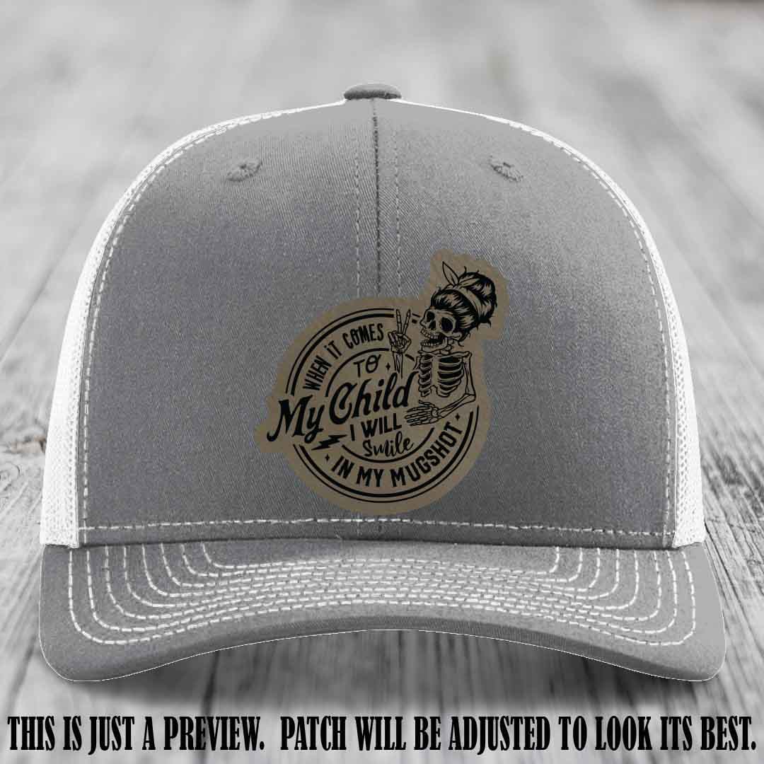 Richardson 112 custom trucker hat with light brown to black patch and 'My Child Mugshot' leather patch on heather grey to white hat
