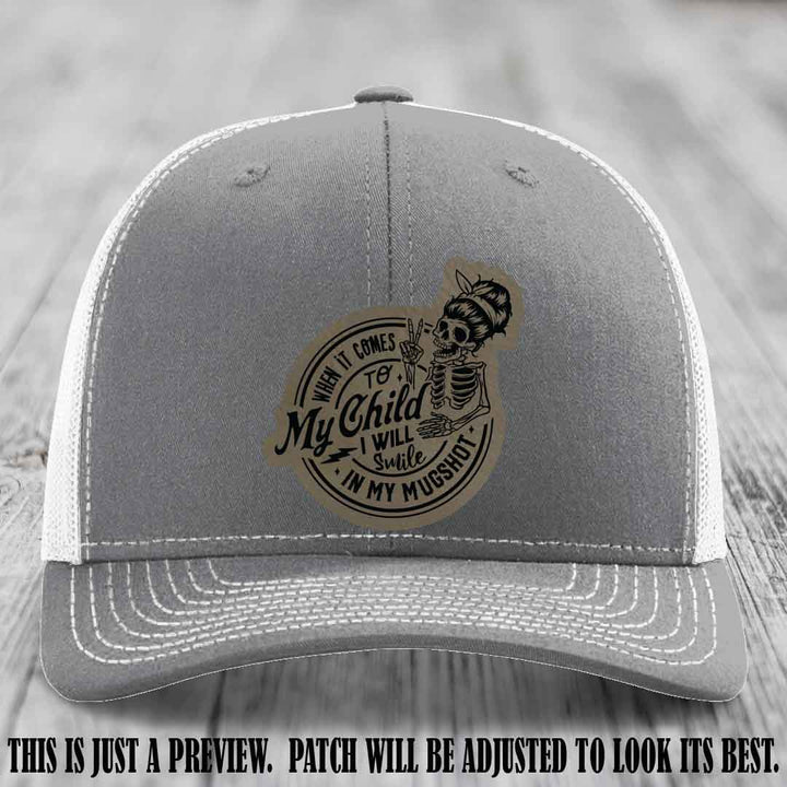 Richardson 112 custom trucker hat with light brown to black patch and 'My Child Mugshot' leather patch on heather grey to white hat
