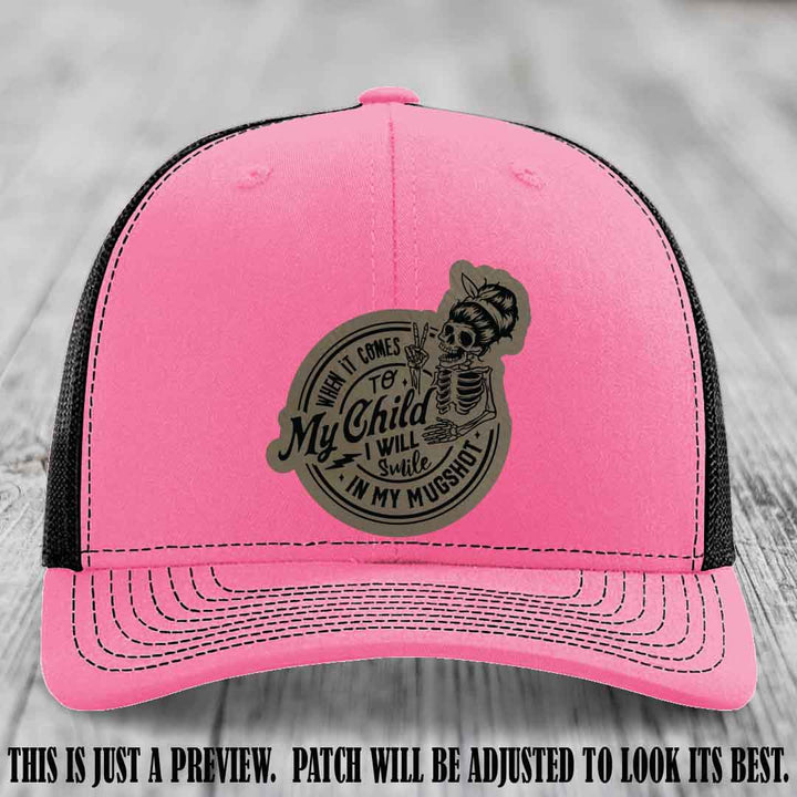 Richardson 112 custom trucker hat with light brown to black patch and 'My Child Mugshot' leather patch on hot pink to black hat