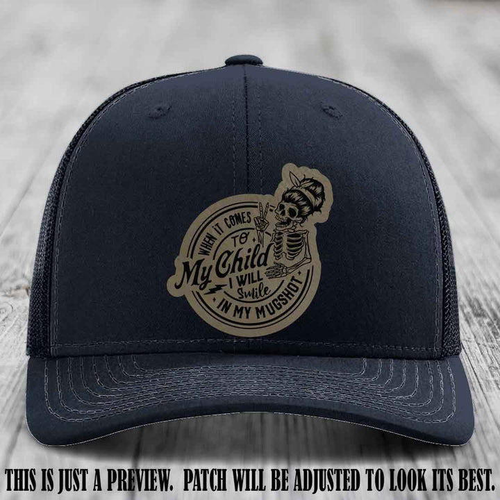 Richardson 112 custom trucker hat with light brown to black patch and 'My Child Mugshot' leather patch on navy hat