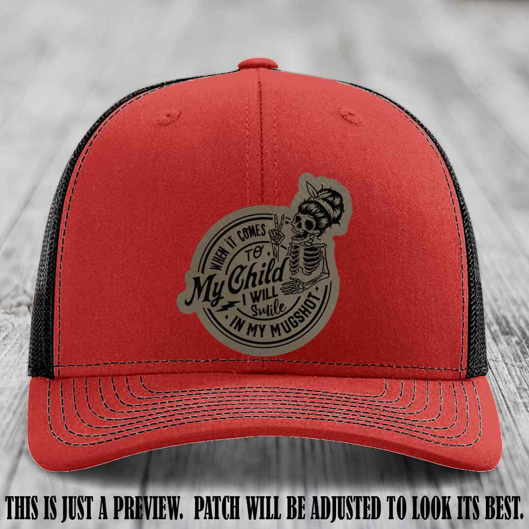 Richardson 112 custom trucker hat with light brown to black patch and 'My Child Mugshot' leather patch on red to black hat