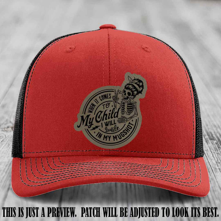 Richardson 112 custom trucker hat with light brown to black patch and 'My Child Mugshot' leather patch on red to black hat