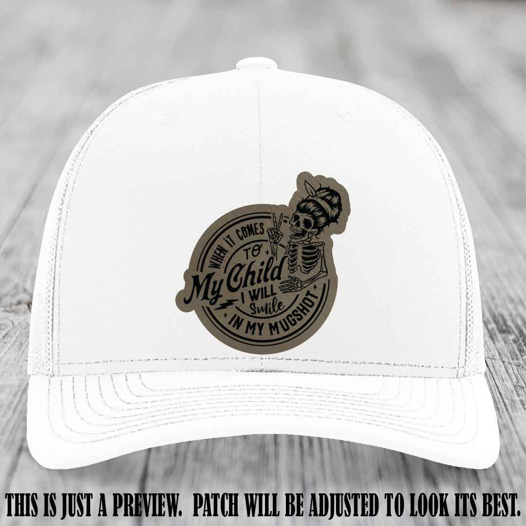 Richardson 112 custom trucker hat with light brown to black patch and 'My Child Mugshot' leather patch on white hat