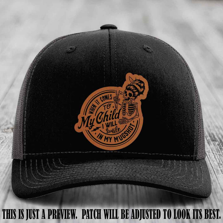 Richardson 112 custom trucker hat with rawhide to black patch and 'My Child Mugshot' leather patch on black to charcoal hat