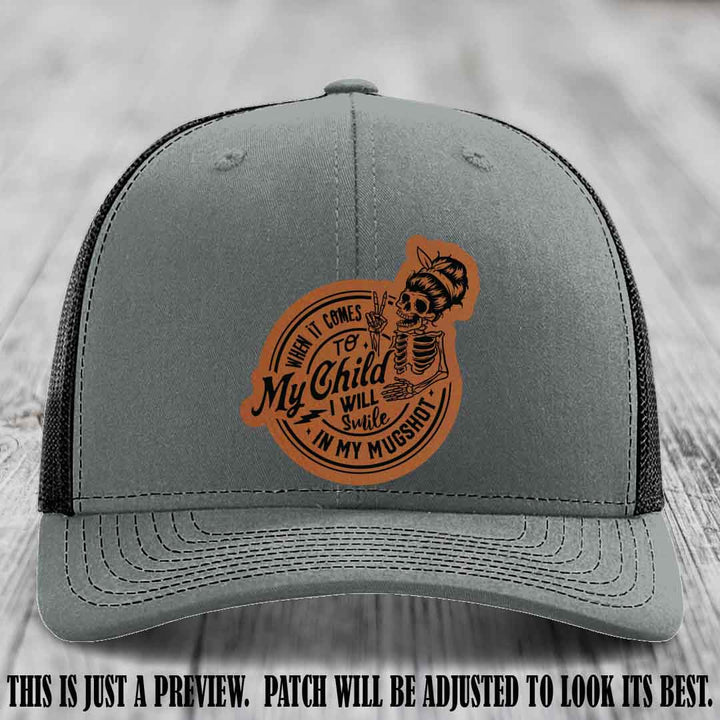 Richardson 112 custom trucker hat with rawhide to black patch and 'My Child Mugshot' leather patch on heather grey to black hat