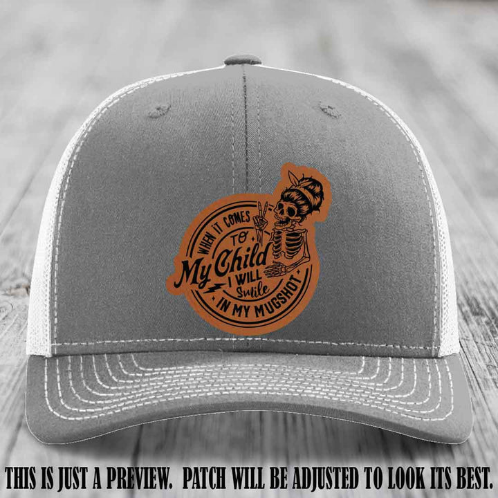Richardson 112 custom trucker hat with rawhide to black patch and 'My Child Mugshot' leather patch on heather grey to white hat