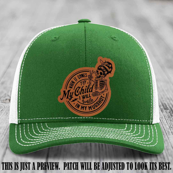 Richardson 112 custom trucker hat with rawhide to black patch and 'My Child Mugshot' leather patch on kelly to white hat
