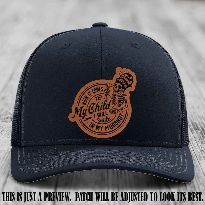 Richardson 112 custom trucker hat with rawhide to black patch and 'My Child Mugshot' leather patch on navy hat