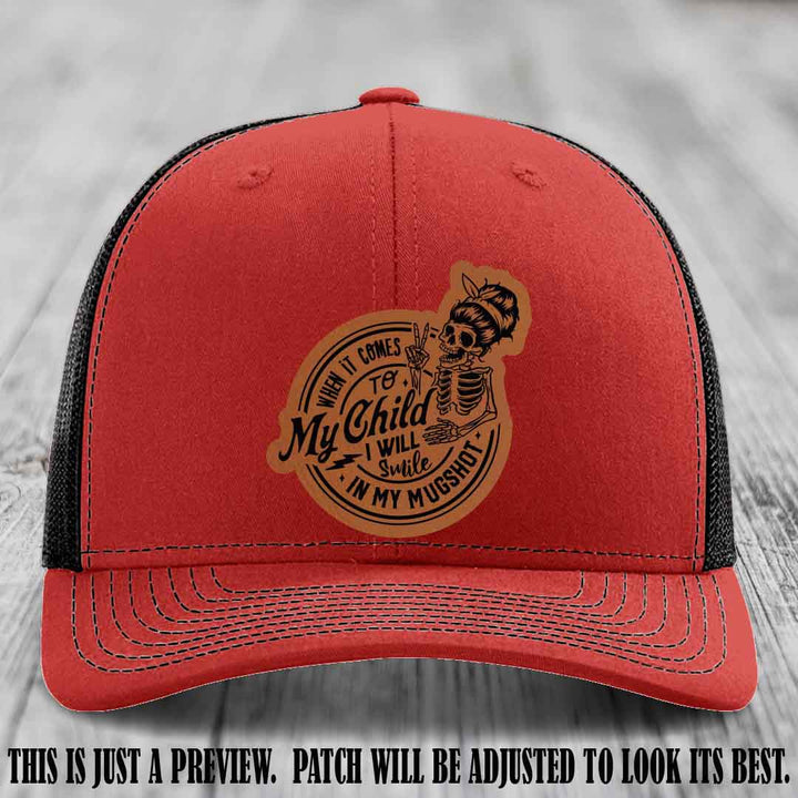 Richardson 112 custom trucker hat with rawhide to black patch and 'My Child Mugshot' leather patch on red to black hat