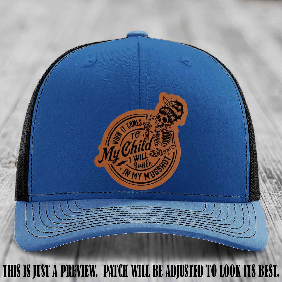 Richardson 112 custom trucker hat with rawhide to black patch and 'My Child Mugshot' leather patch on royal to black hat